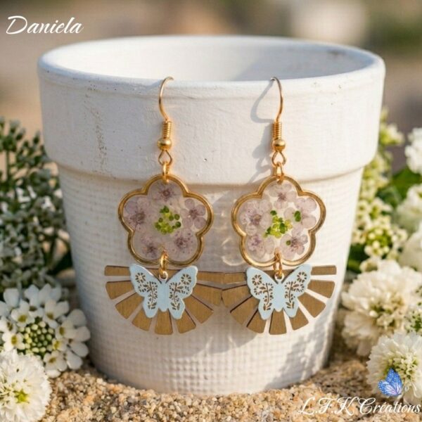Daniela Boucles Blanches Papillons : boucles d'oreilles bohème en fleurs séchées et résine portées par une femme.