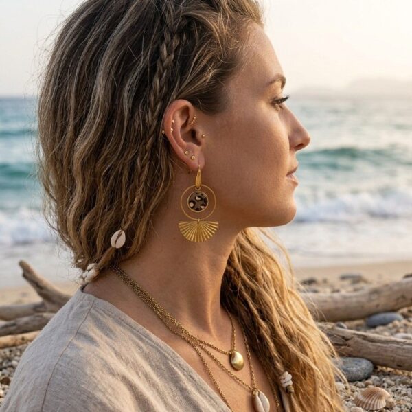 Portrait d'une femme portant les boucles d'oreilles asymétriques Samia, montrant la légèreté et le style sauvage élégant du modèle léopard et or.