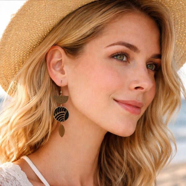 "Portrait rapproché des boucles d'oreilles Yuna portées, illustrant le mouvement des breloques dorées et l'élégance du tissu japonais noir sur le visage."